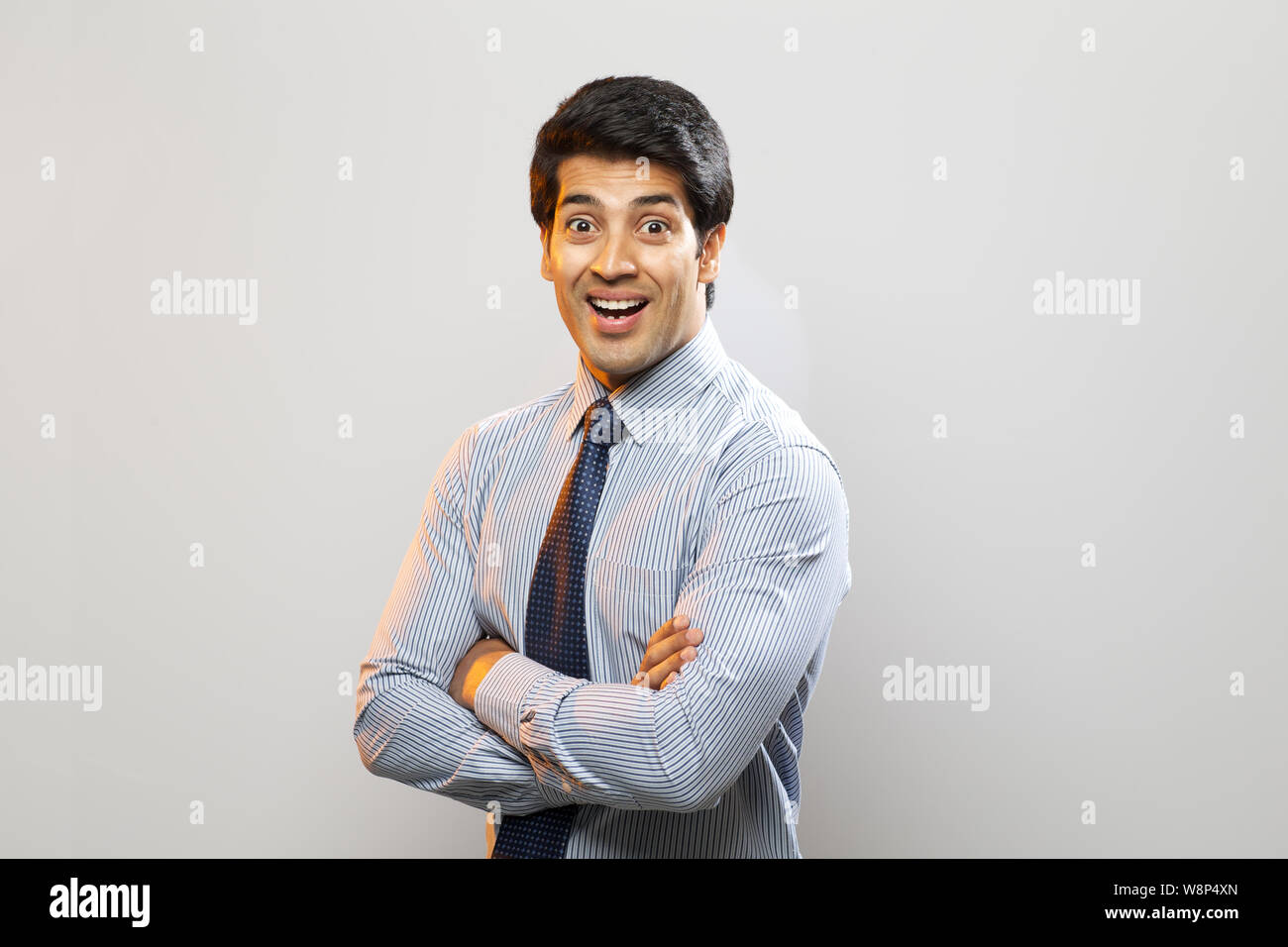 Businessman smiling with his arms crossed Stock Photo - Alamy
