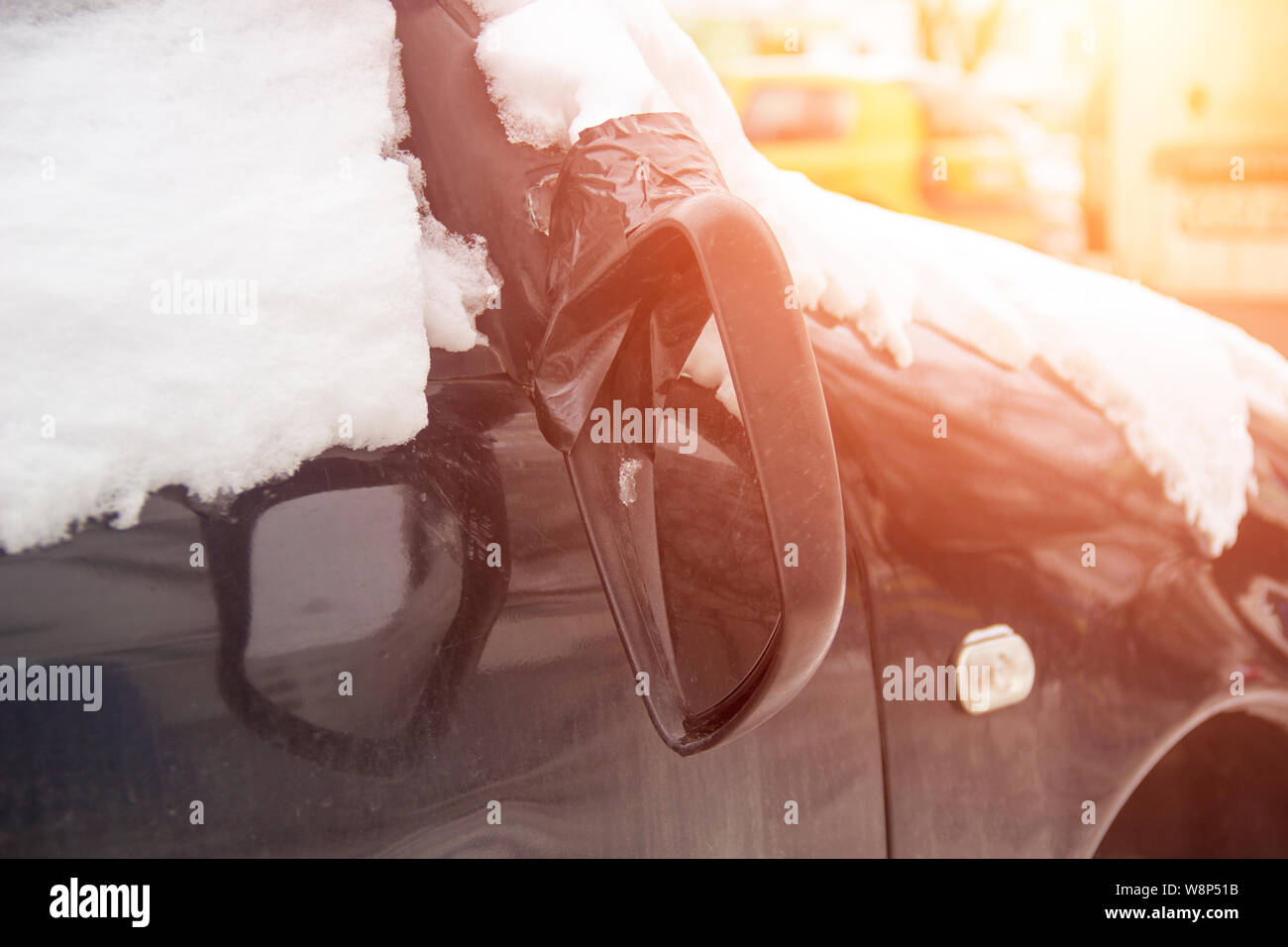 Broken car mirror on a car, concept of road accident and car insurance