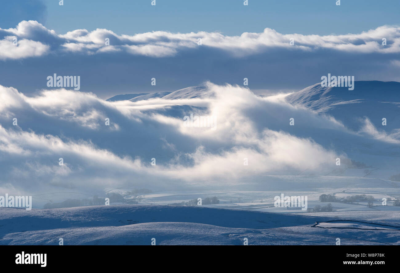 Bank of freezing fog covering the Howgill Fells on a winters afternoon, Cumbria, UK. Stock Photo