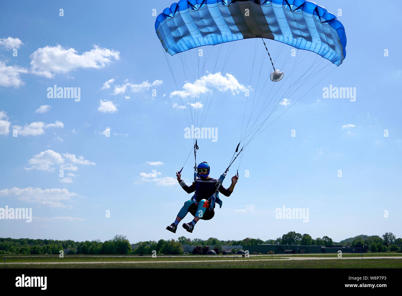 Man with a blue little canopy of a parachute is flies, closeup. High