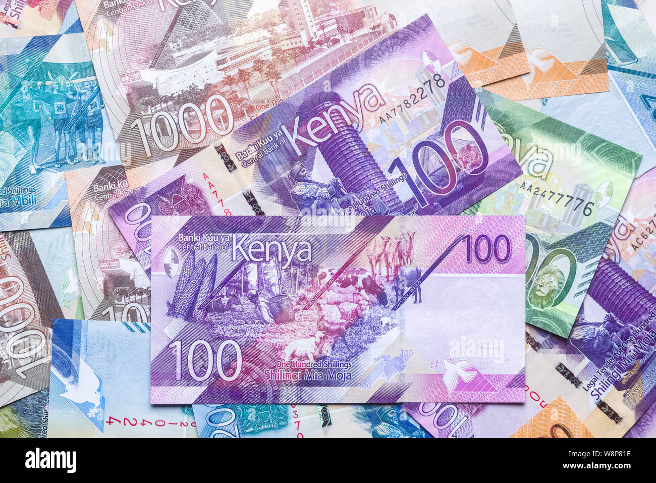 New 2019 Kenyan 100 Shilling bank notes on top of other bank notes in various denominations Stock Photo