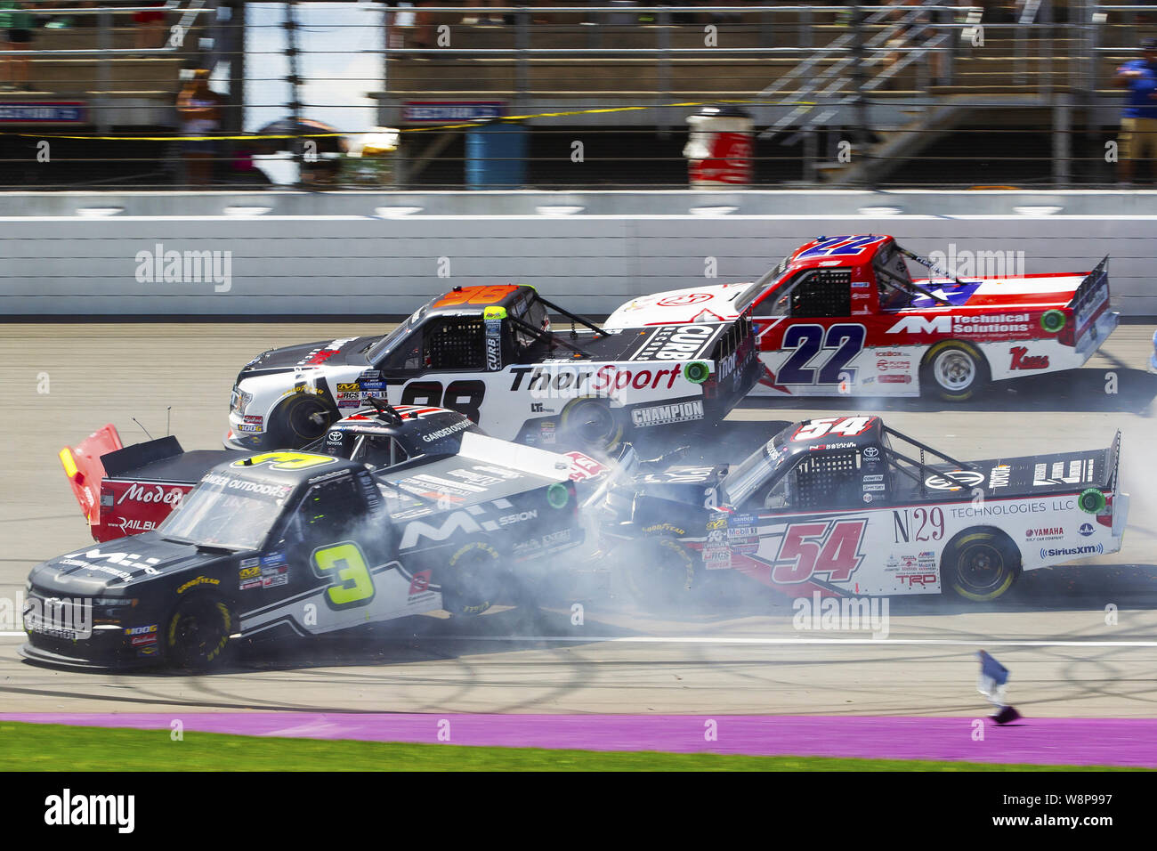 Brooklyn, Michigan, USA. 10th Aug, 2019. Gander Outdoors Truck Series driver NATALIE DECKER (54) and JORDAN ANDERSON (3) crash just before turn one during the 20th Annual Corrigan Oil 200 at Michigan International Speedway. Credit: Scott Mapes/ZUMA Wire/Alamy Live News Stock Photo