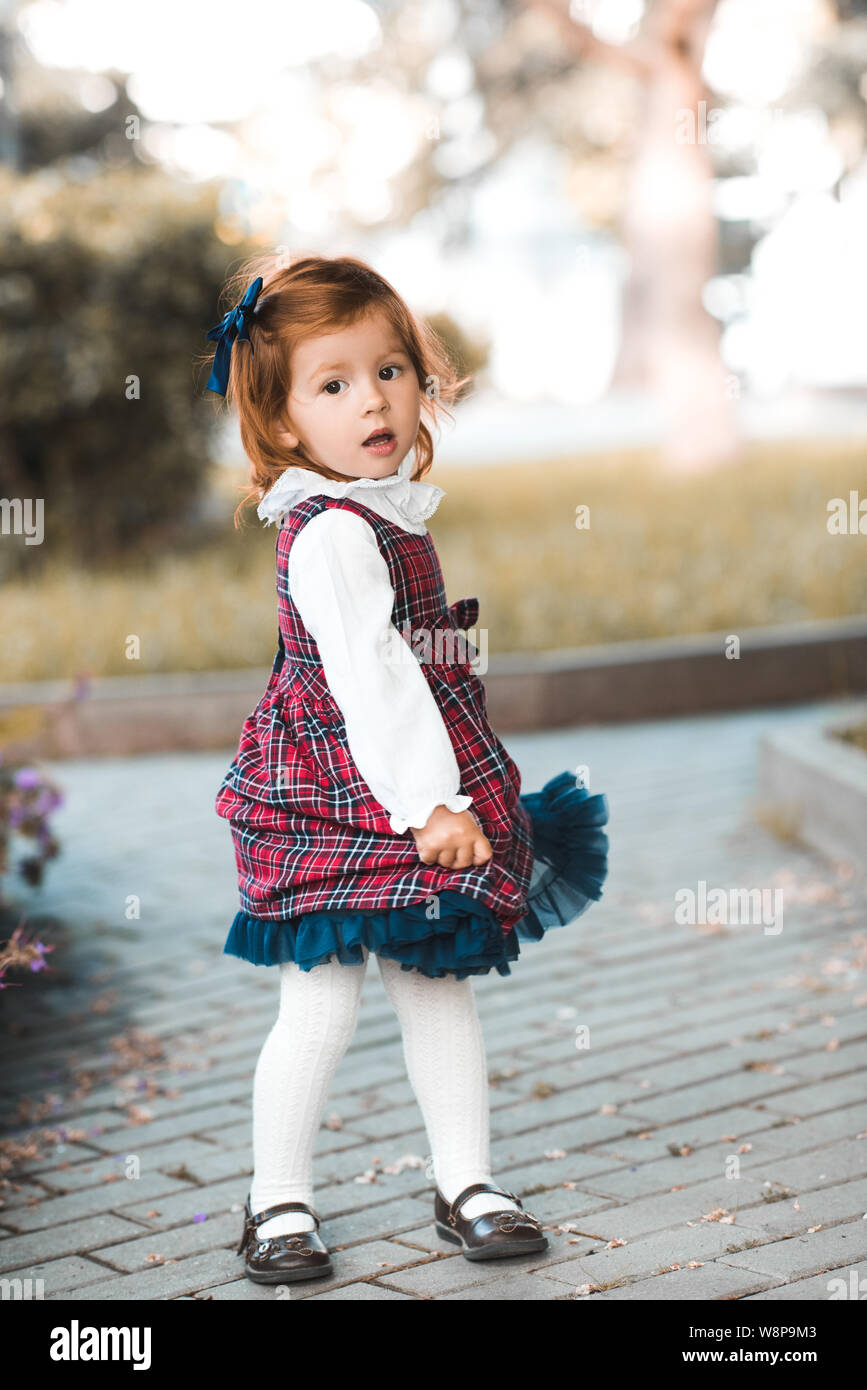 Cute baby girl 2-3 year old wearing stylish dress posing in park ...