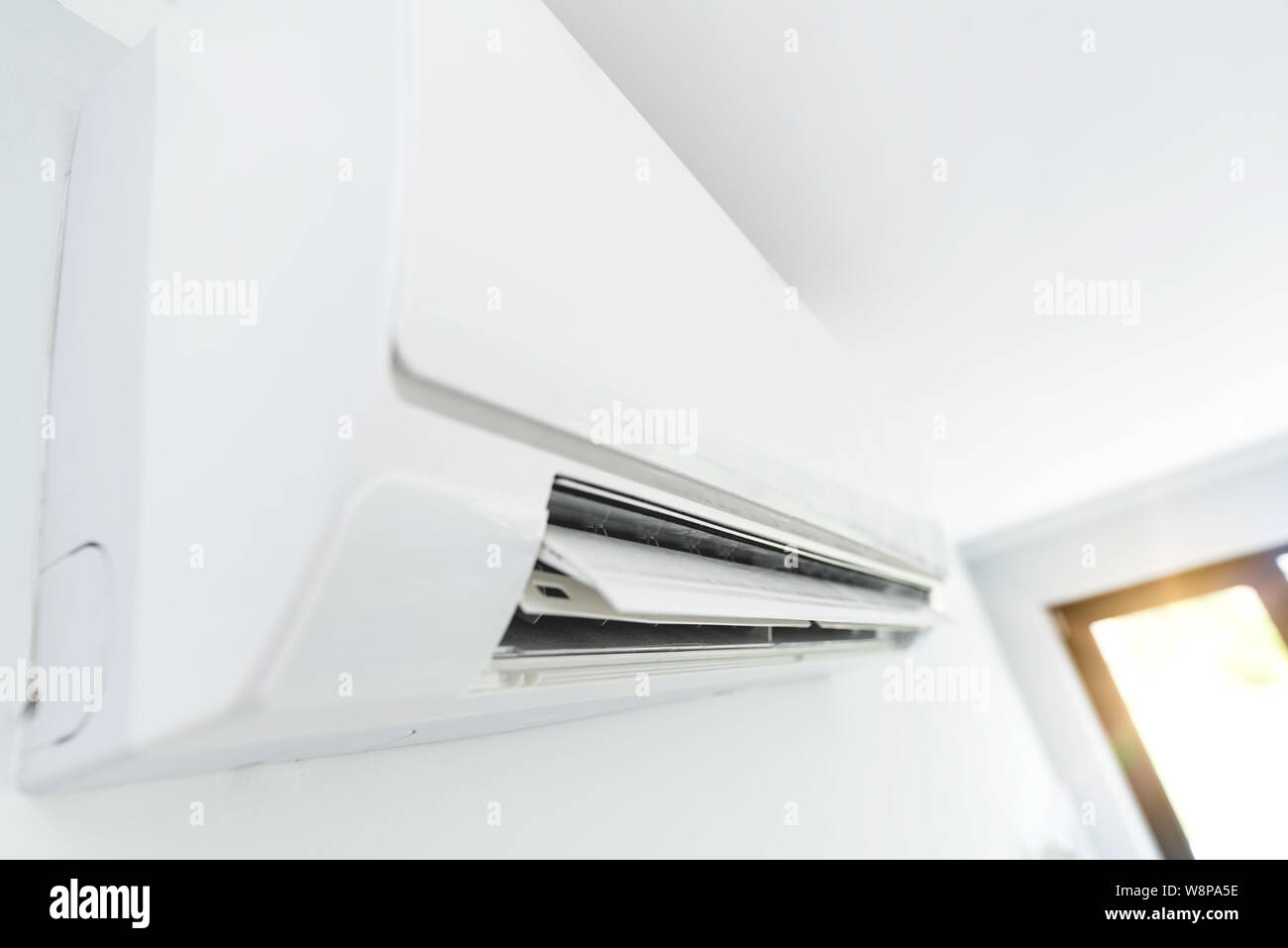 Air conditioner split hanging on the wall. Cooling device in room Stock