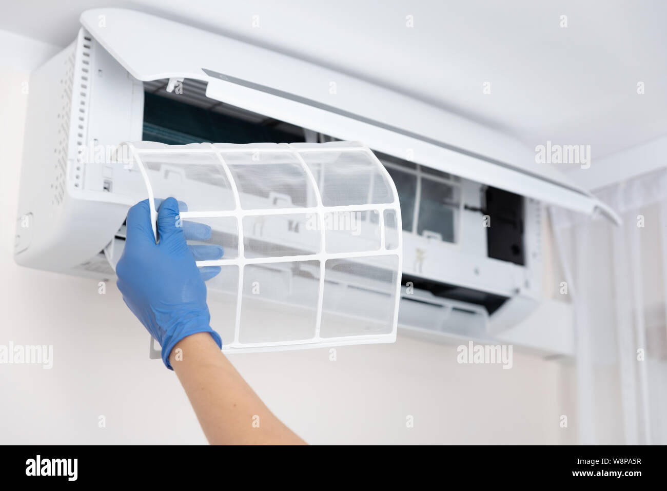 Technician cleaning air conditioner. Hand holding air conditioning