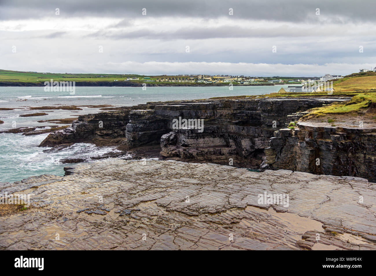 Surrounding the seaside town of Kilkee, County Clare, Ireland are interesting cliffs with many unique rock formations Stock Photo