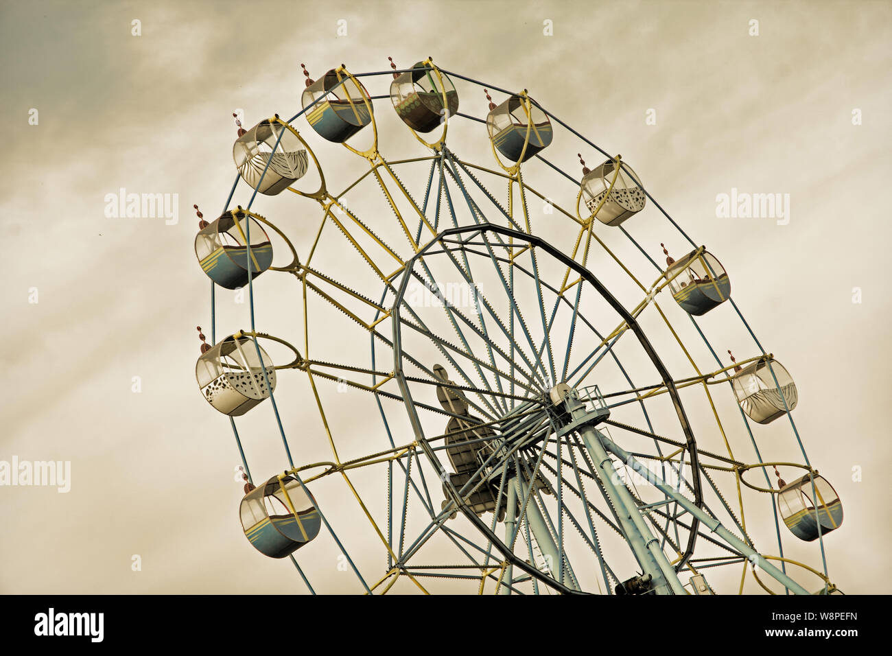 Apocalyptic ferris wheel on acrid sky grey backround. Chernobylconcept. Stock Photo