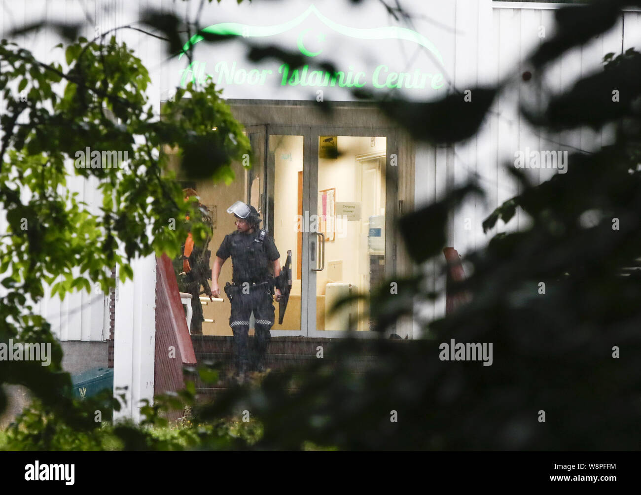 Oslo, Norway. 10th august, 2019. (190810) -- OSLO, Aug. 10, 2019 (Xinhua) -- A police officer walks out of the Al-Noor Islamic Center after a shooting in Baerum, near Oslo, Norway, on Aug. 10, 2019. A dead person was found after the Mosque shooting outside Oslo on Saturday, and it was being investigated in related to the shooting incident, police said late Saturday. (NTB Scanpix/Handout via Xinhua) Credit: Xinhua/Alamy Live News Stock Photo