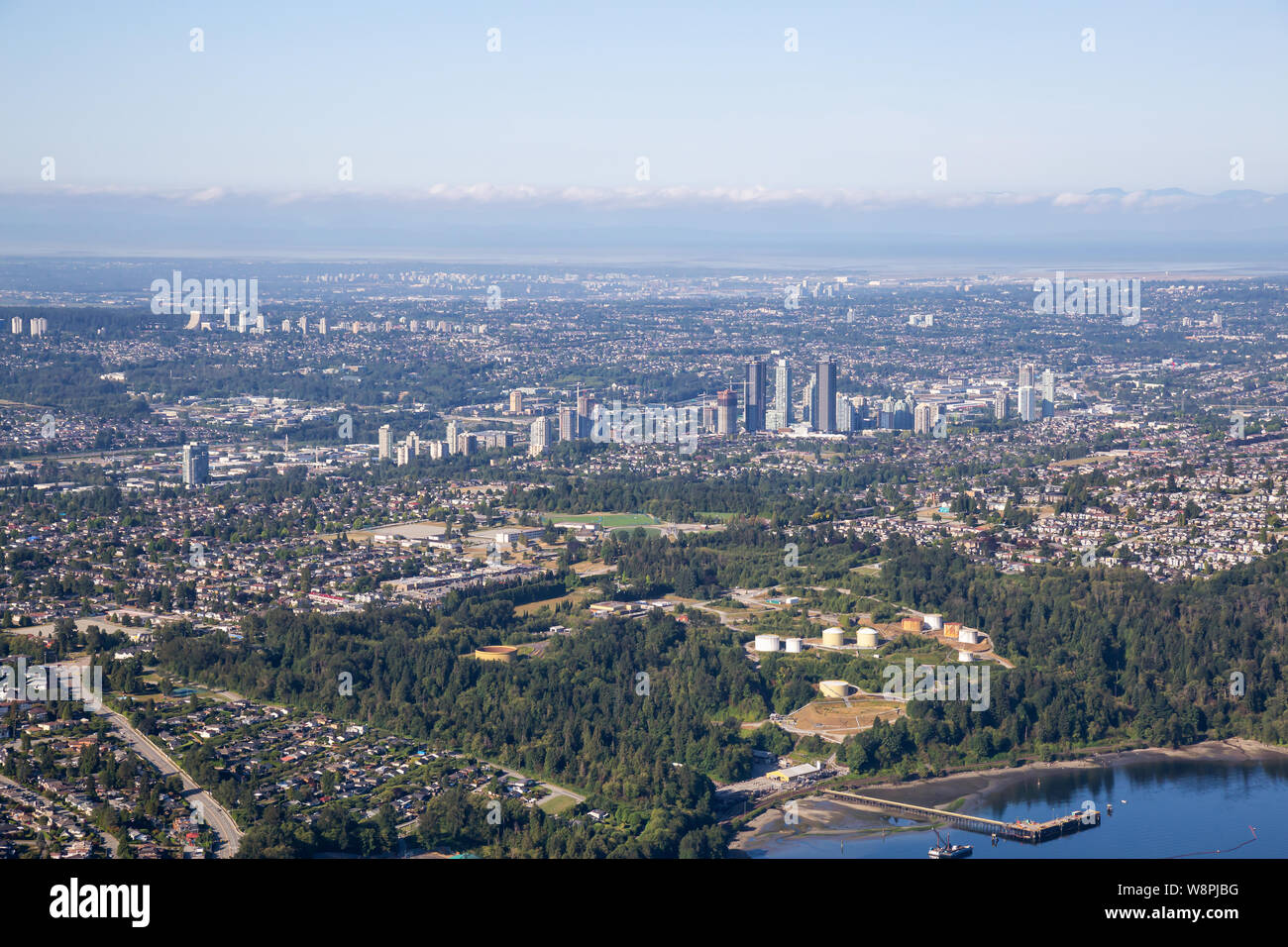 Aerial view of a modern cityscape during a sunny summer morning. Taken