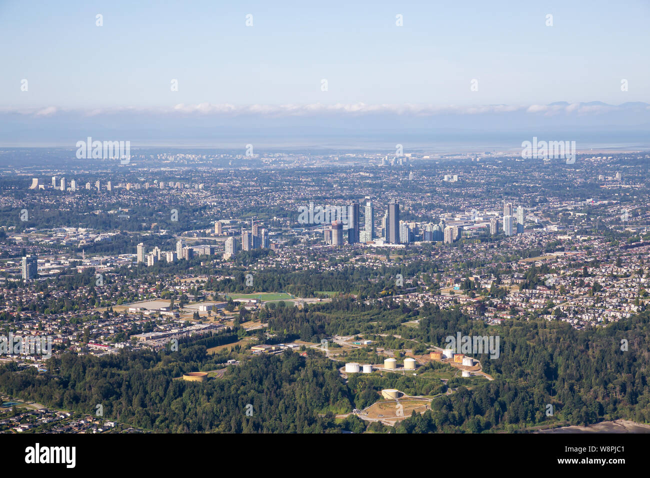 Aerial view of a modern cityscape during a sunny summer morning. Taken