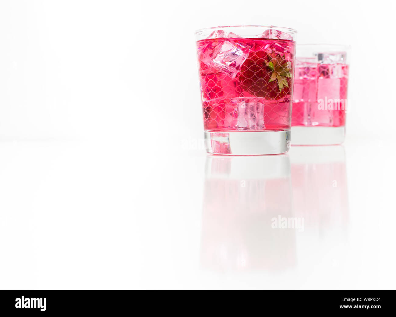 Strawberry vodka and lemonade in a galss isolated on white background Stock Photo