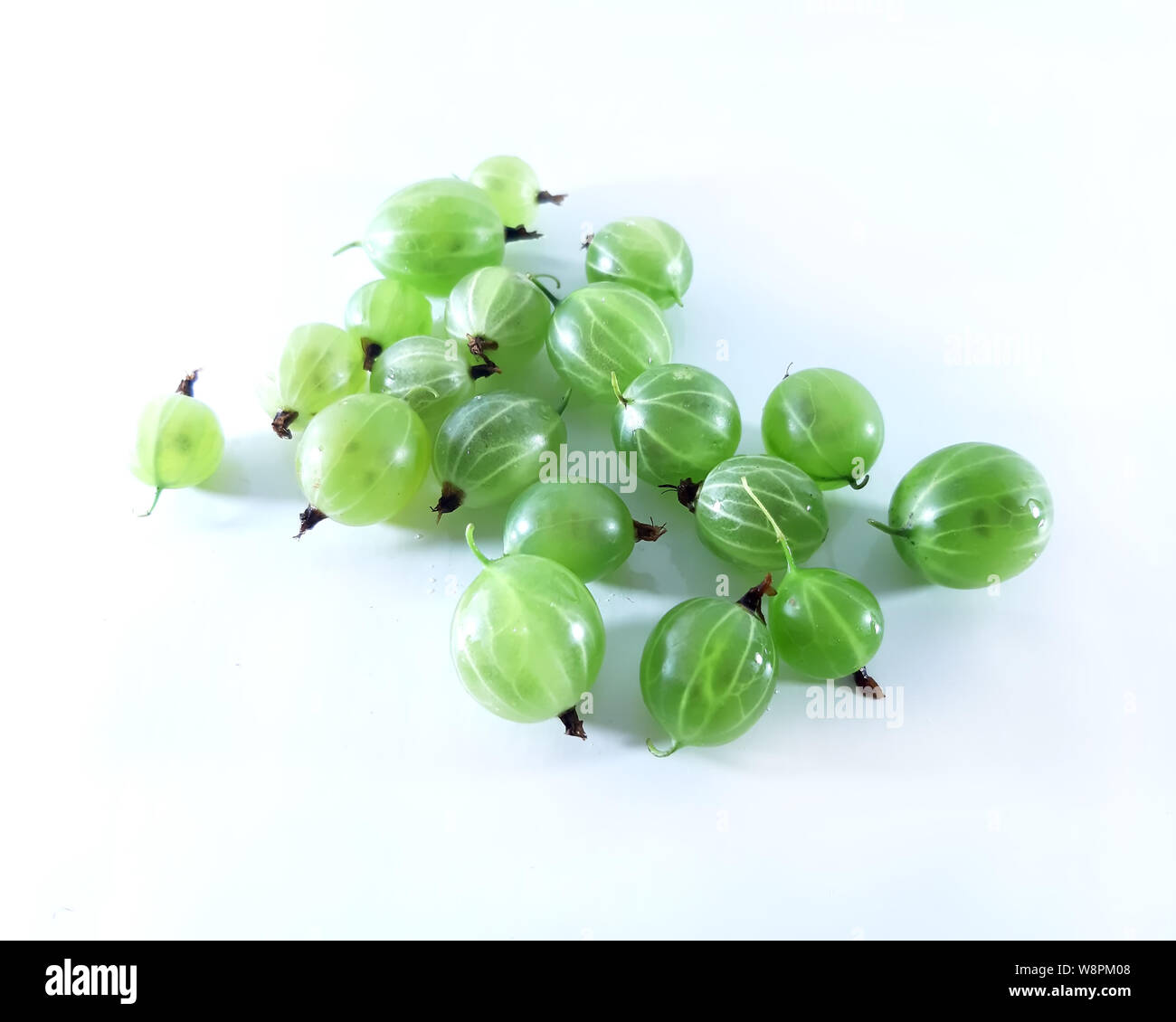 Green gooseberry, white background. Vegetarian, diet food, photo modern close up Stock Photo