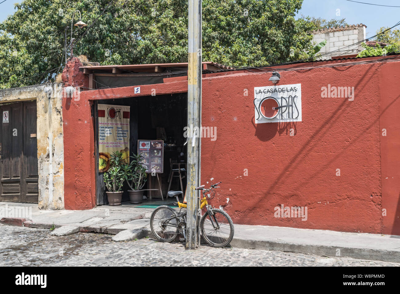 Exterior shot of the restaurant La Casa de Las Sopas, with a cobblestone  street and a bicycle leaning on a post, in Antigua, Guatemala Stock Photo -  Alamy