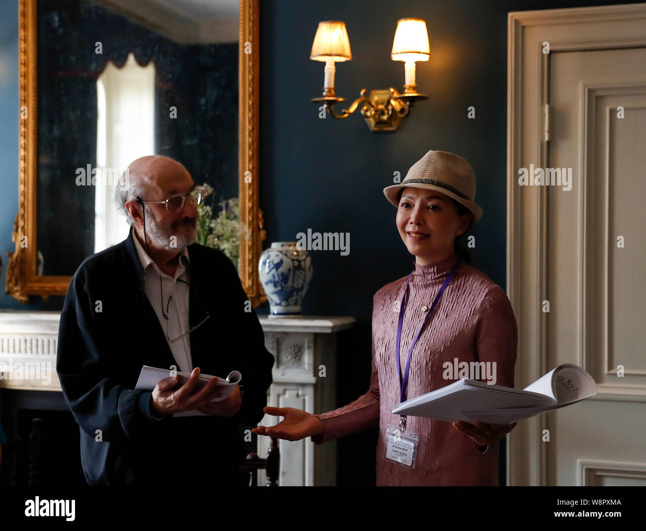 Beijing, Cambridge. 9th Aug, 2019. A poet (L) reads his poem with a Chinese professional reader during the 5th Cambridge Xu Zhimo Poetry and Art Festival 2019 at King's College, University of Cambridge, in Cambridge, Britain on Aug. 9, 2019. Credit: Han Yan/Xinhua/Alamy Live News Stock Photo
