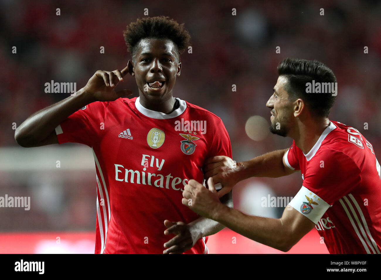 Lisbon, Portugal. 10th Aug, 2019. Benfica's Nuno Tavares (L) celebrates after scoring during the Portuguese league football match between Benfica and Pacos de Ferreira in Lisbon, Portugal, on Aug. 10, 2019. Credit: Petro Fiuza/Xinhua/Alamy Live News Stock Photo