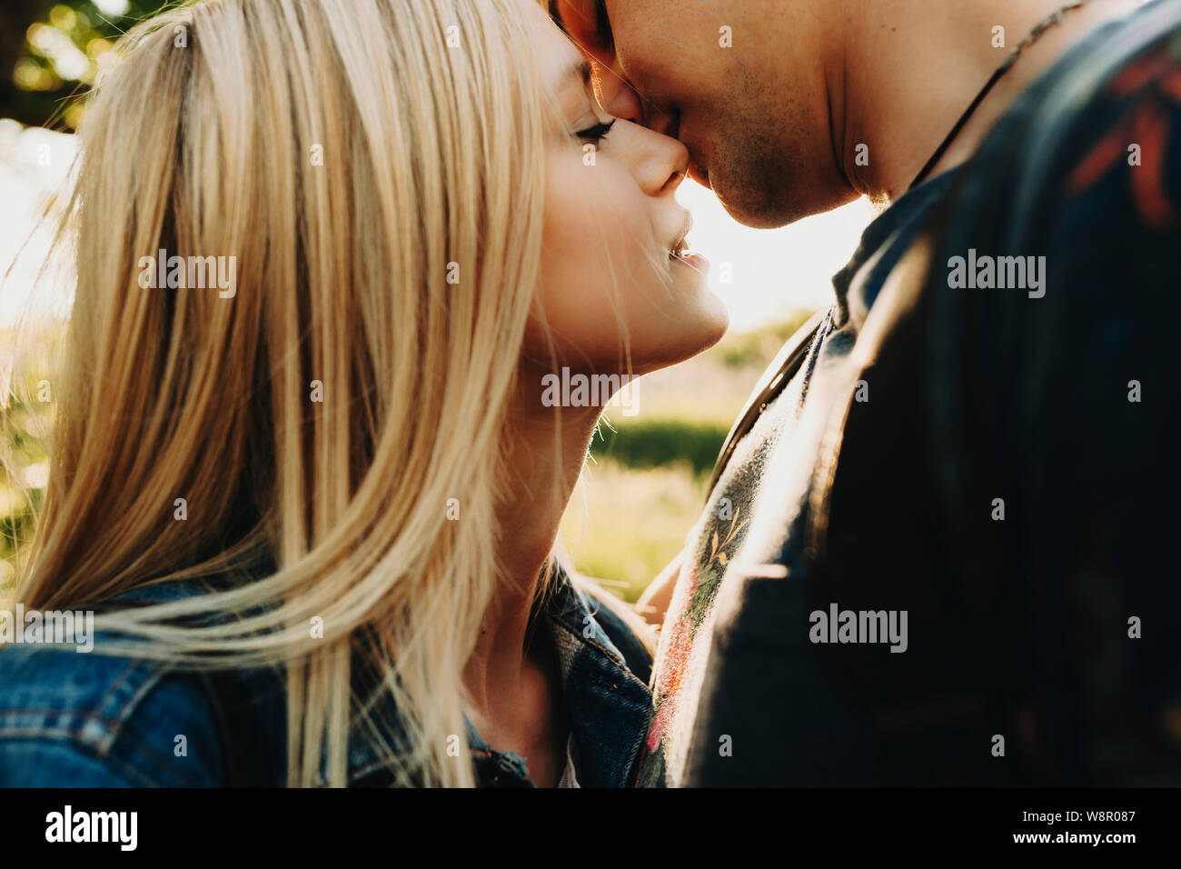 Pregnant woman and her husband on light blue background, space for text Sto...