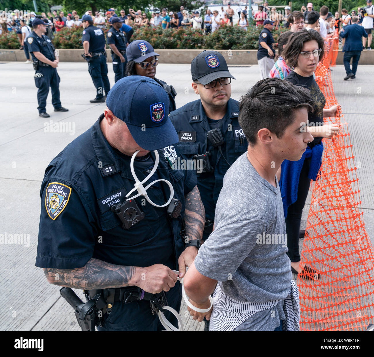 New York, NY - August 10, 2019: Police officers arrest member of Rise and Resist group at protest to shut down ICE & close camps for disorderly conduct for shutting West Side highway in Chelsea area Stock Photo