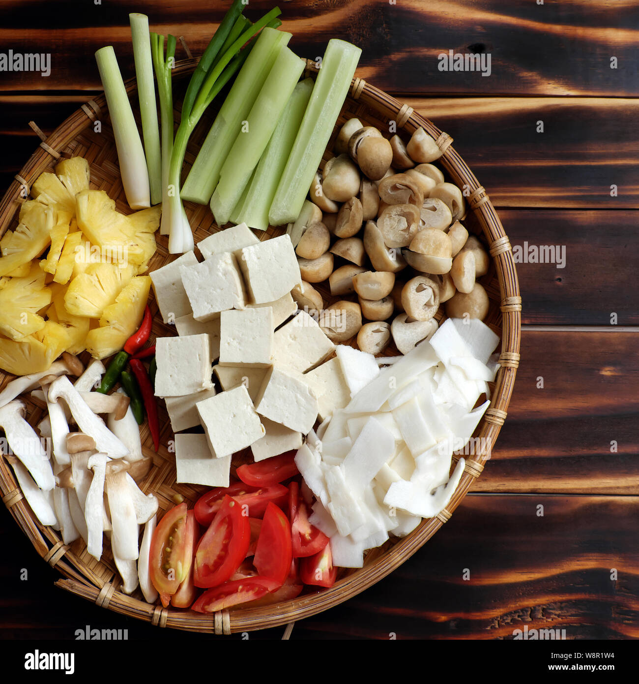 Top view food processing for vegetarian meal, vegetables soup from raw ingredients as tomato, pineapple, bamboo shoot and tofu, mushroom, simple dish Stock Photo