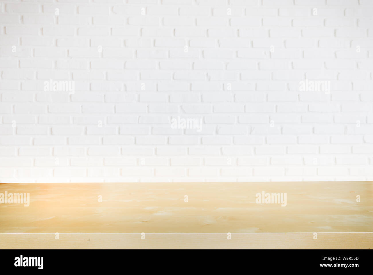 Empty black wood office table with white brick wall and copy space