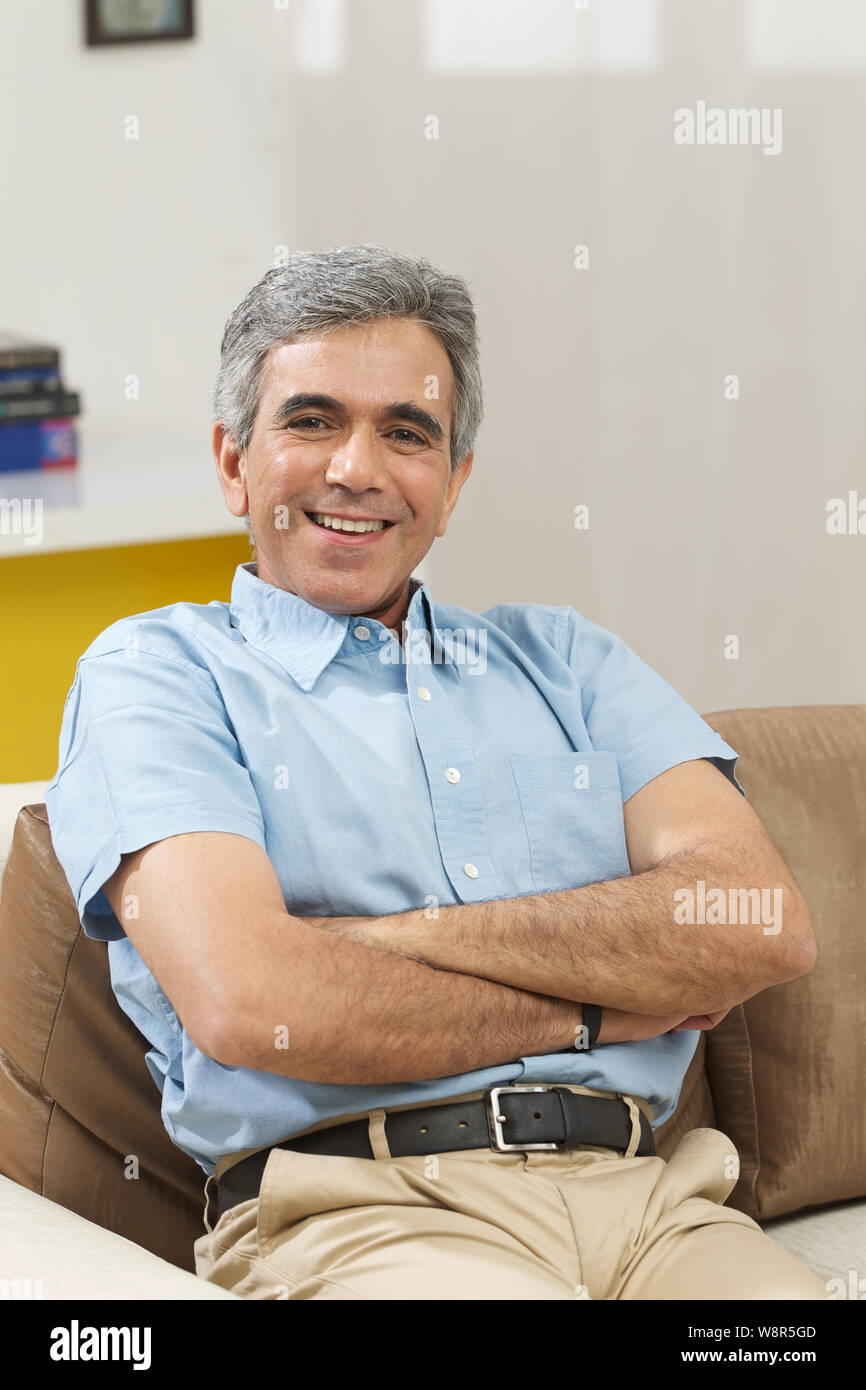 Senior man smiling with his arms crossed Stock Photo - Alamy