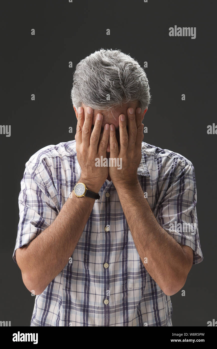 Senior man covering his face with hands Stock Photo - Alamy