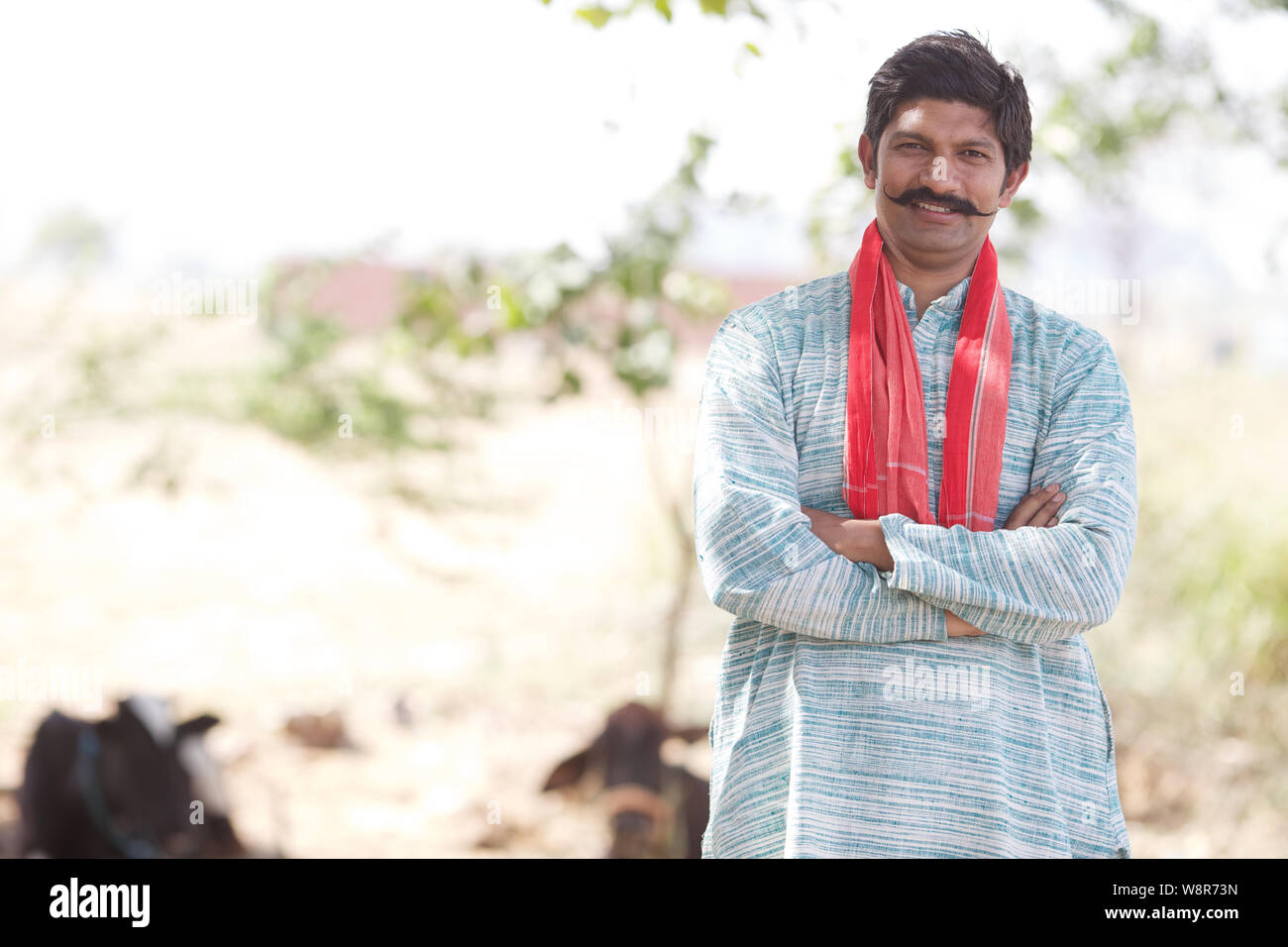 Portrait of a farmer smiling with his arms crossed Stock Photo - Alamy