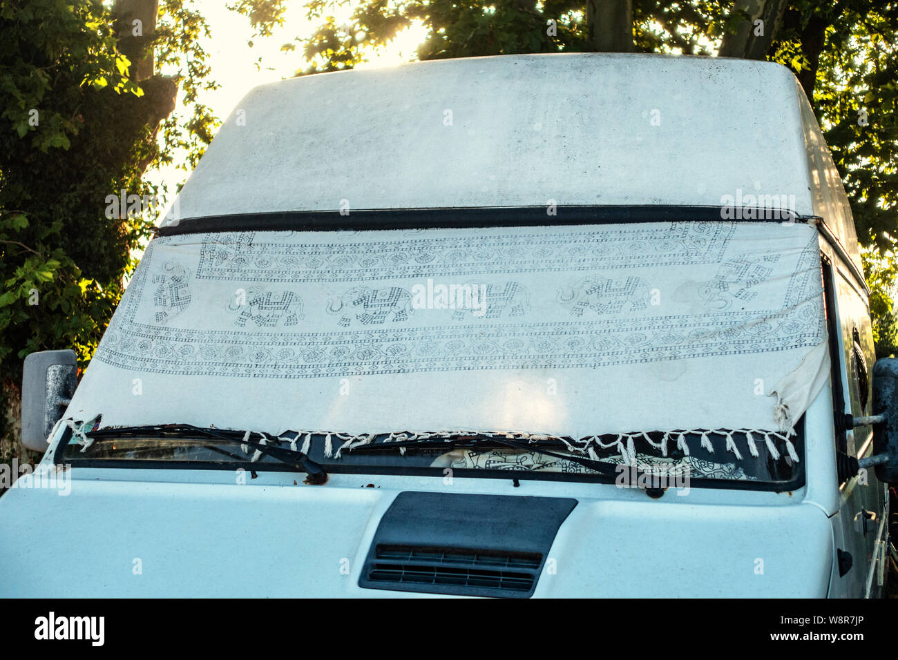 Camper van with windscreen shielded from the sun with a sheet Stock Photo