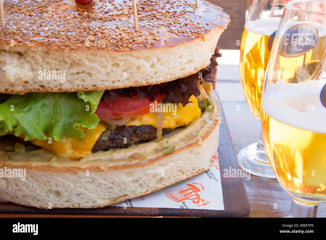 Large one kilo Beef burger in a bun served at Tipsi beer and burger house, Icmeler, Mugla province, Turkey Stock Photo