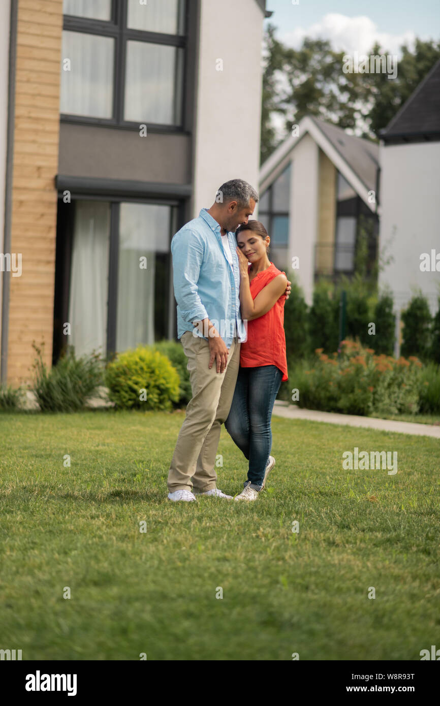 Couple standing outside near their cottage house at the weekend Stock ...