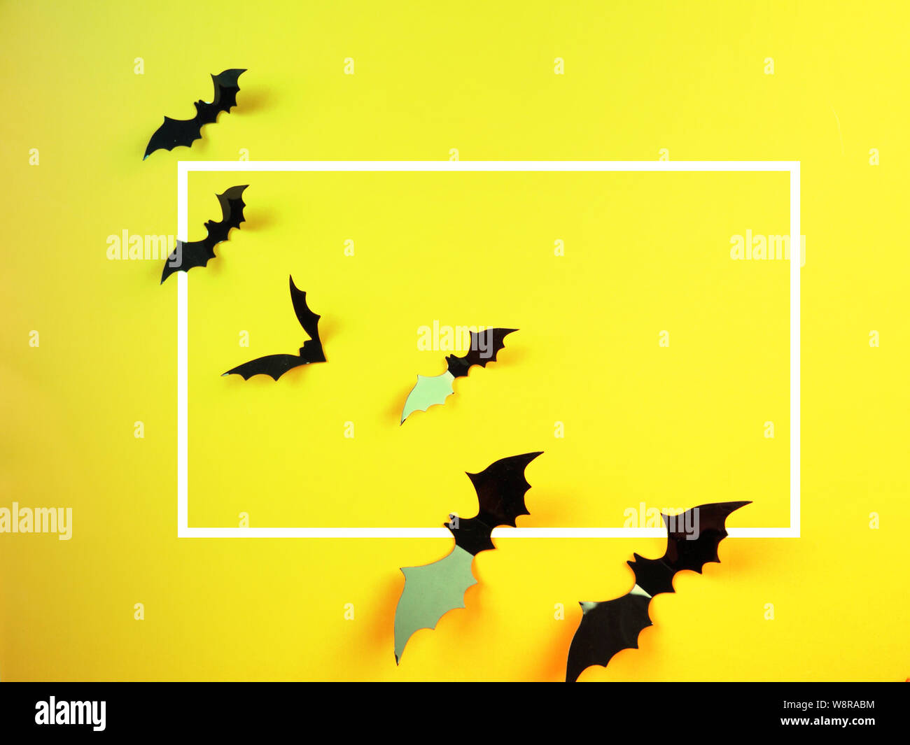 Halloween bats on orange and yellow background in neon toning with ...