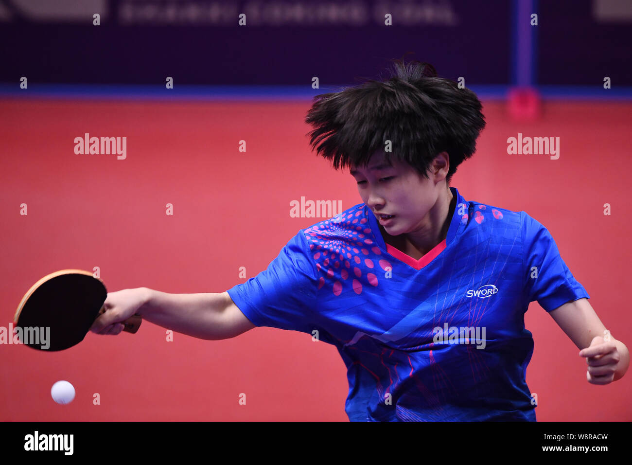 China s Zhang Qi competes against Britain s David Smith in the