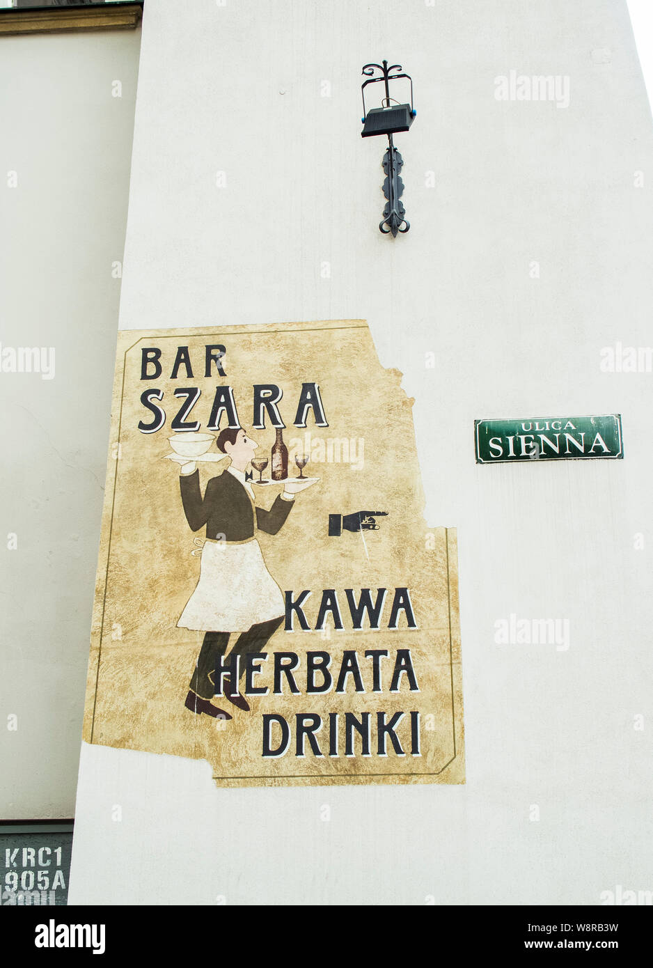 Krakow, Poland-June 10,2015: weathered sign with a direction arrow  to a bar Stock Photo
