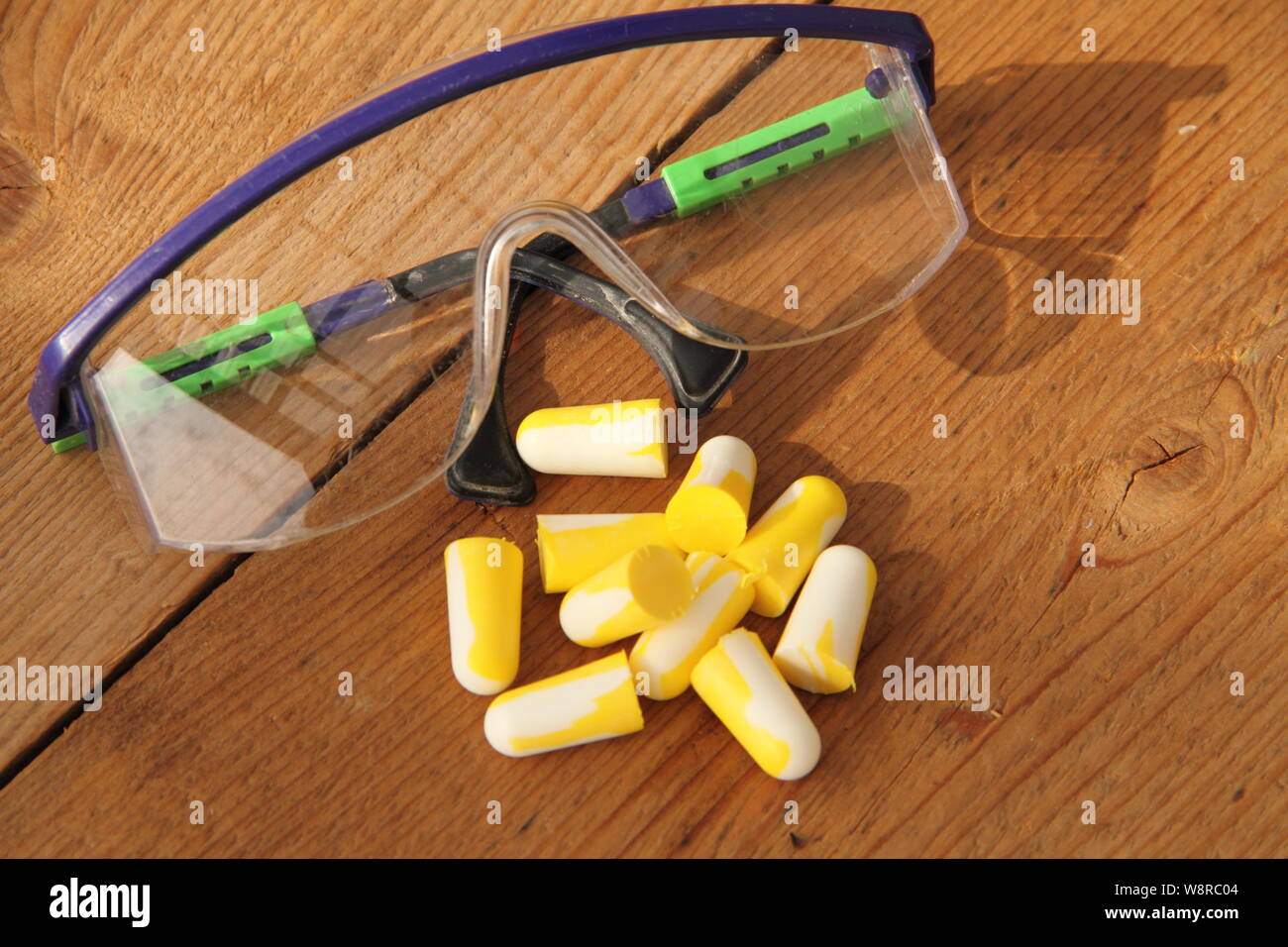 Earplugs and protective goggles for work safety Stock Photo Alamy