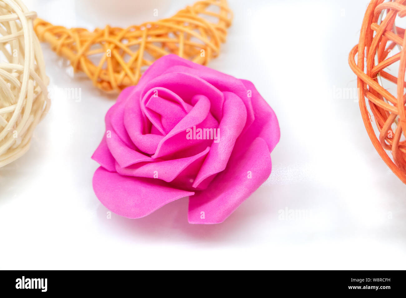 Rattan ball and material flower on white Stock Photo