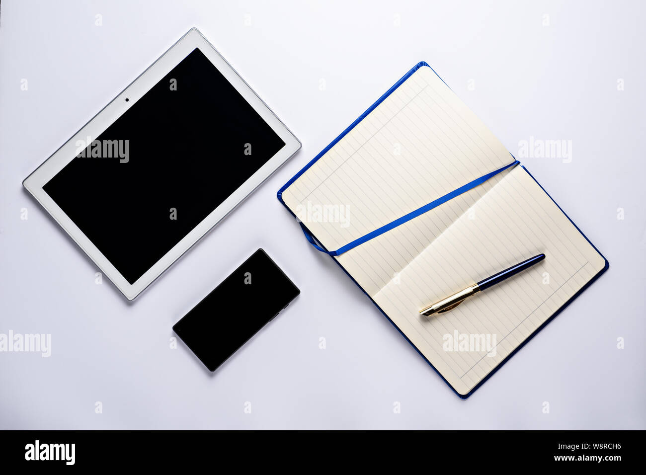 Business design flat lay, notepad with pen, smartphone and tablet top ...