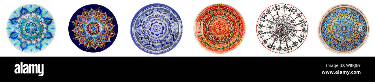 Set of decorative ceramic dishes hand-painted with acrylic paints floral pattern isolated on white background. Stock Photo