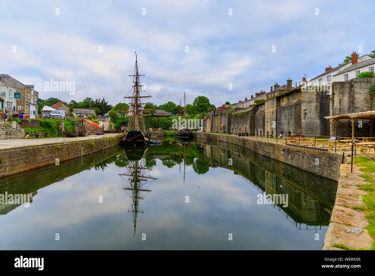 CHARLESTOWN, CORNWALL, UK - JUNE 30 2019: A view of the harbour in Charlestown near St Austell in Cornwall. Historic Tall Ships moored to the quayside Stock Photo