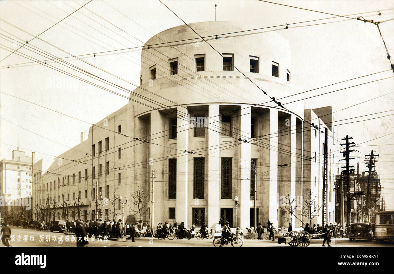 [ 1930s Japan - Osaka Stock Exchange ] —   Osaka Stock Exchange (大阪株式取引所). It was orginally located elsewhere, but moved to Kitamaha in 1894 (Meiji 27). Construction started immediately, but because new extensions were added continuously, it wasn’t completed until 1911 (Meiji 44). That building was replaced by the building in this image in 1935 (Showa 10). This was torn down, too, but its iconic circular entrance still stands today.  20th century vintage postcard. Stock Photo