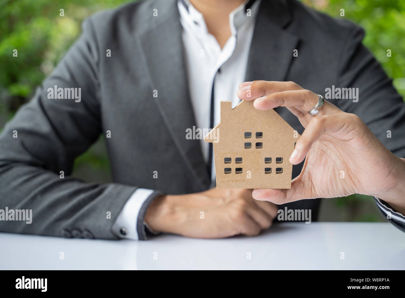 holding house representing home ownership and the Real Estate business. Stock Photo