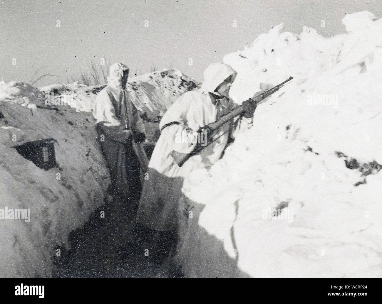 German Soldiers in White Snow Camouflage in a trench on the Russian Front during the Winter of 1942 Stock Photo
