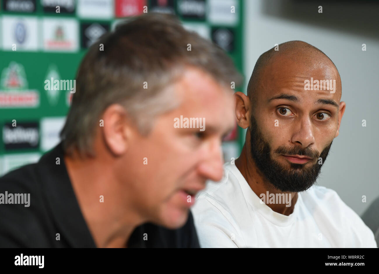Bremen, Germany. 11th Aug, 2019. Frank Baumann (l), Managing Director Sport of Werder Bremen, sits next to Ömer Toprak at a press conference. Toprak comes on loan with purchase option from Borussia Dortmund. Credit: Carmen Jaspersen/dpa - IMPORTANT NOTE: In accordance with the requirements of the DFL Deutsche Fußball Liga or the DFB Deutscher Fußball-Bund, it is prohibited to use or have used photographs taken in the stadium and/or the match in the form of sequence images and/or video-like photo sequences./dpa/Alamy Live News Stock Photo