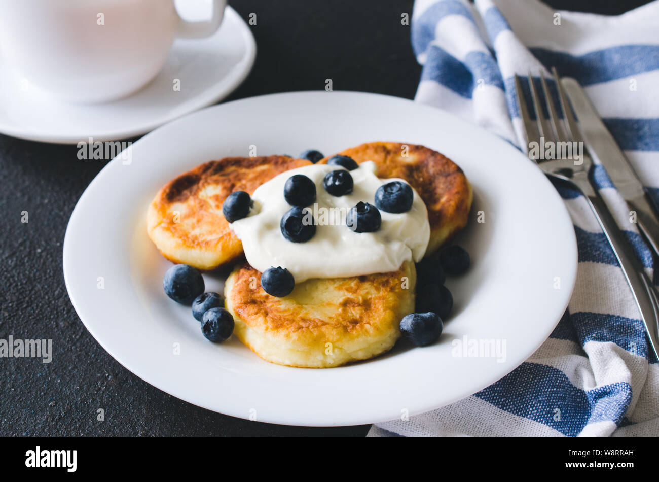 Cottage Cheese Pancakes Or Syrniki For Breakfast With Sour Cream