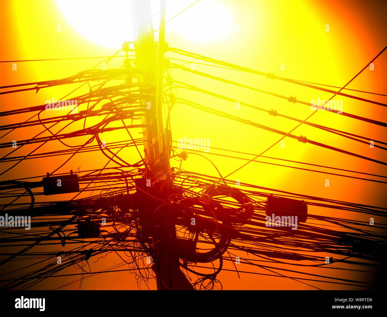 Incredible tangle of electric cables on yellow sky in bangkok thailand, Cables silhouette Stock Photo