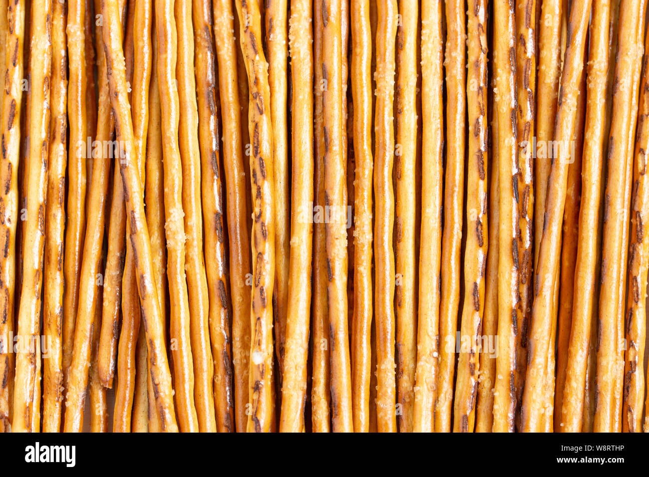 Sweet breadsticks closeup, dough straw texture, cracker biscuit snac
