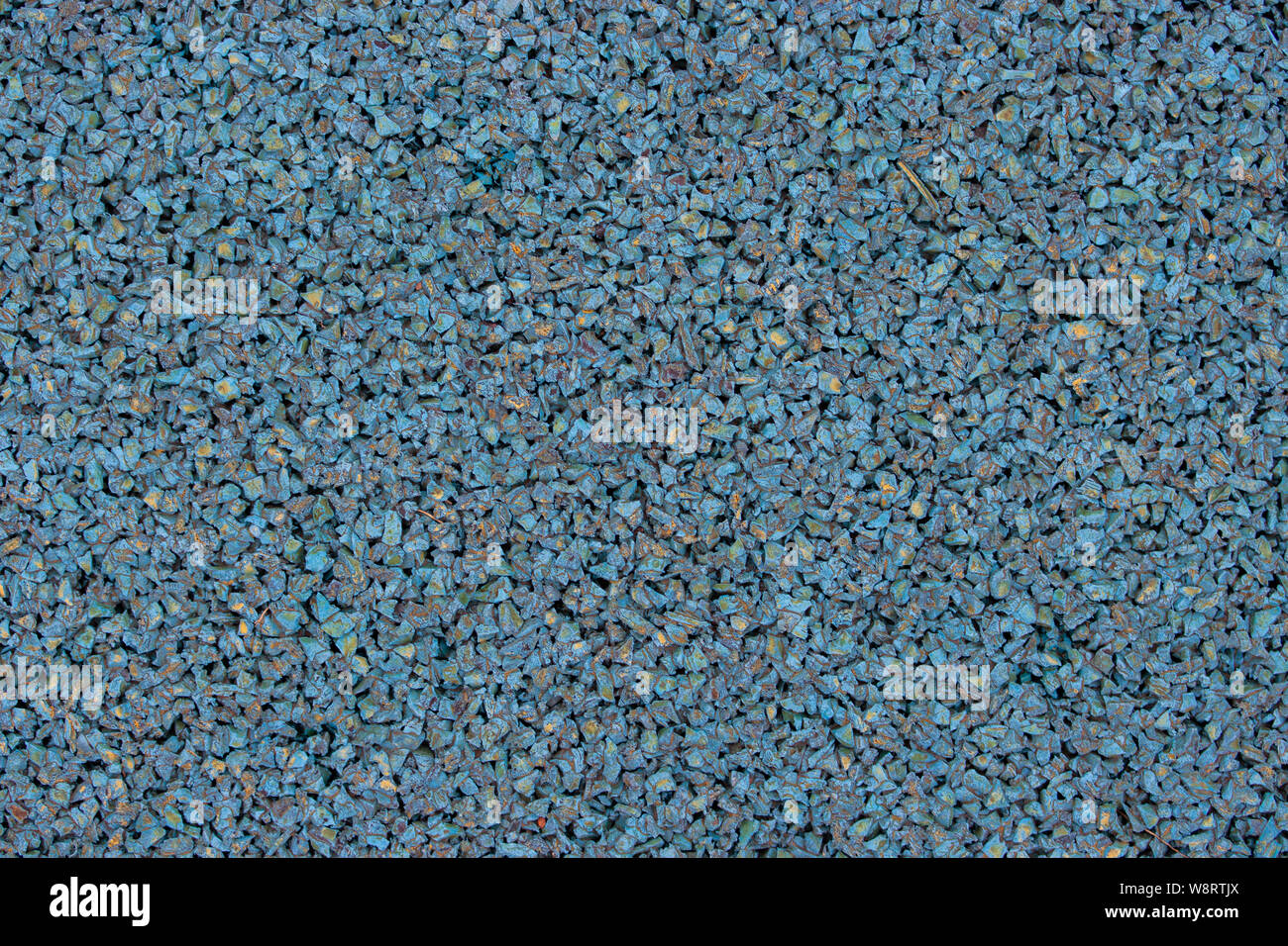 Blue rubber covering of a sports ground for children. Texture granule