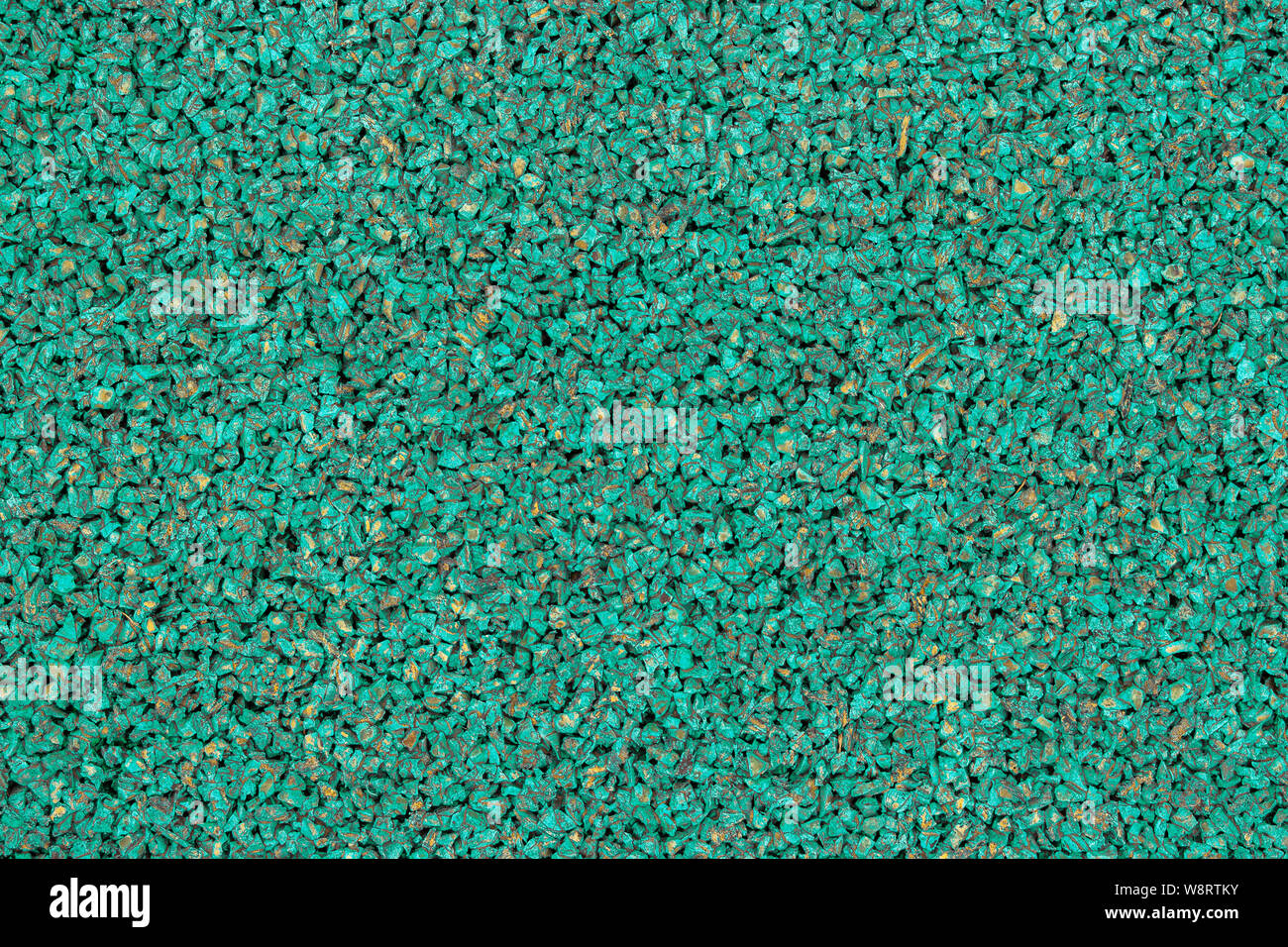 Green rubber covering of a sports ground for children. Texture granule