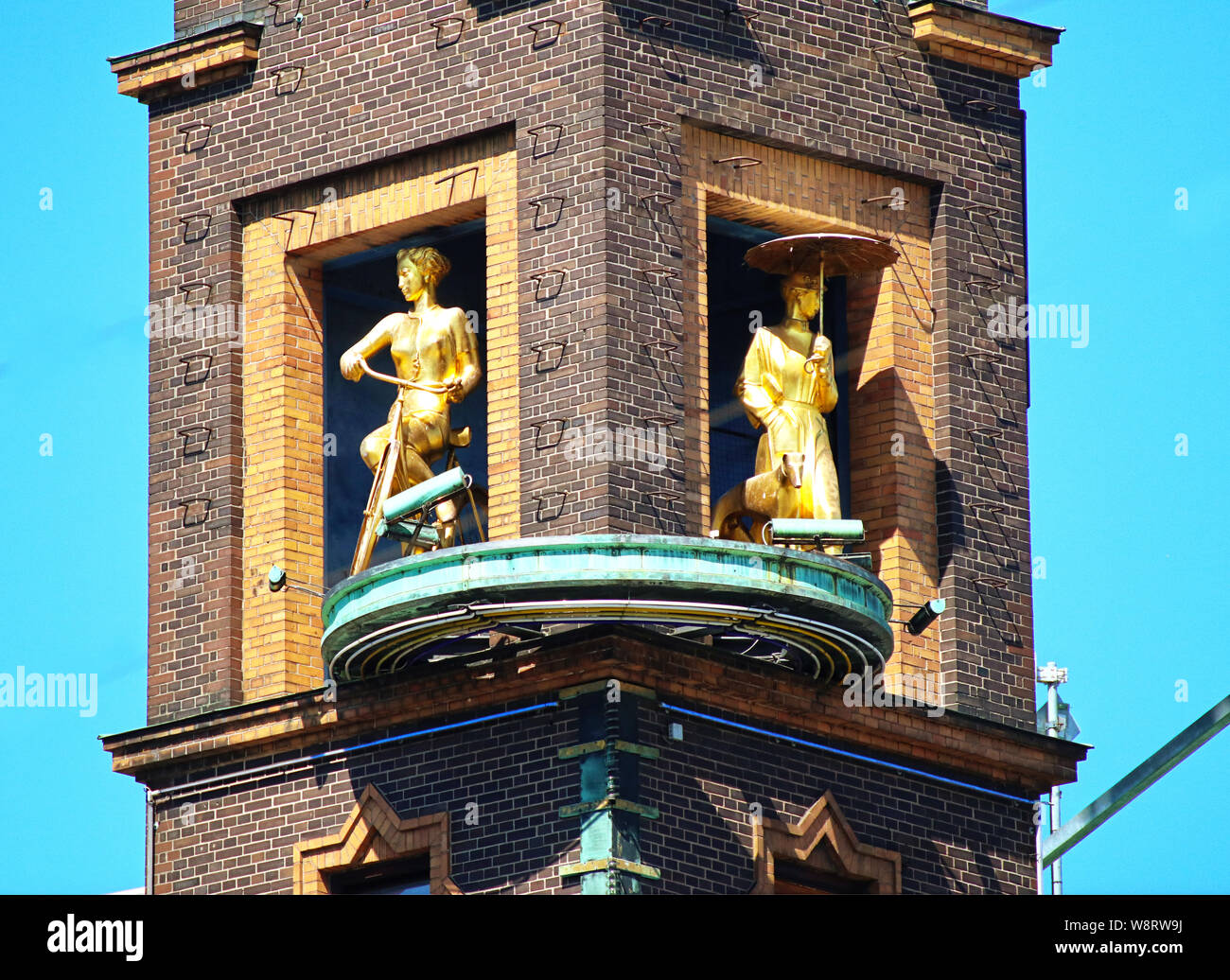 COPENHAGEN, DENMARK - JUNE 14, 2019 Copenhagen, Radhuspladsen: the weather girl, a golden sculpture rotating group telling the weather: the girl with Stock Photo