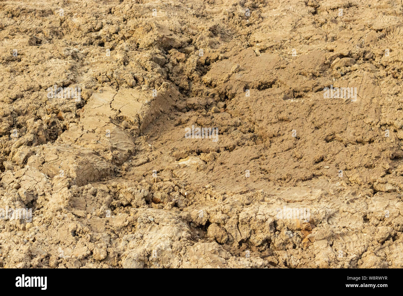 Ground dirt soil soil sand clay alumina texture background close-up, clay soil around the construction site Stock Photo
