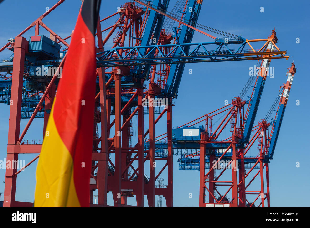 container terminal Germany flag Container ship export free trade economy container gantry crane export world champion Stock Photo