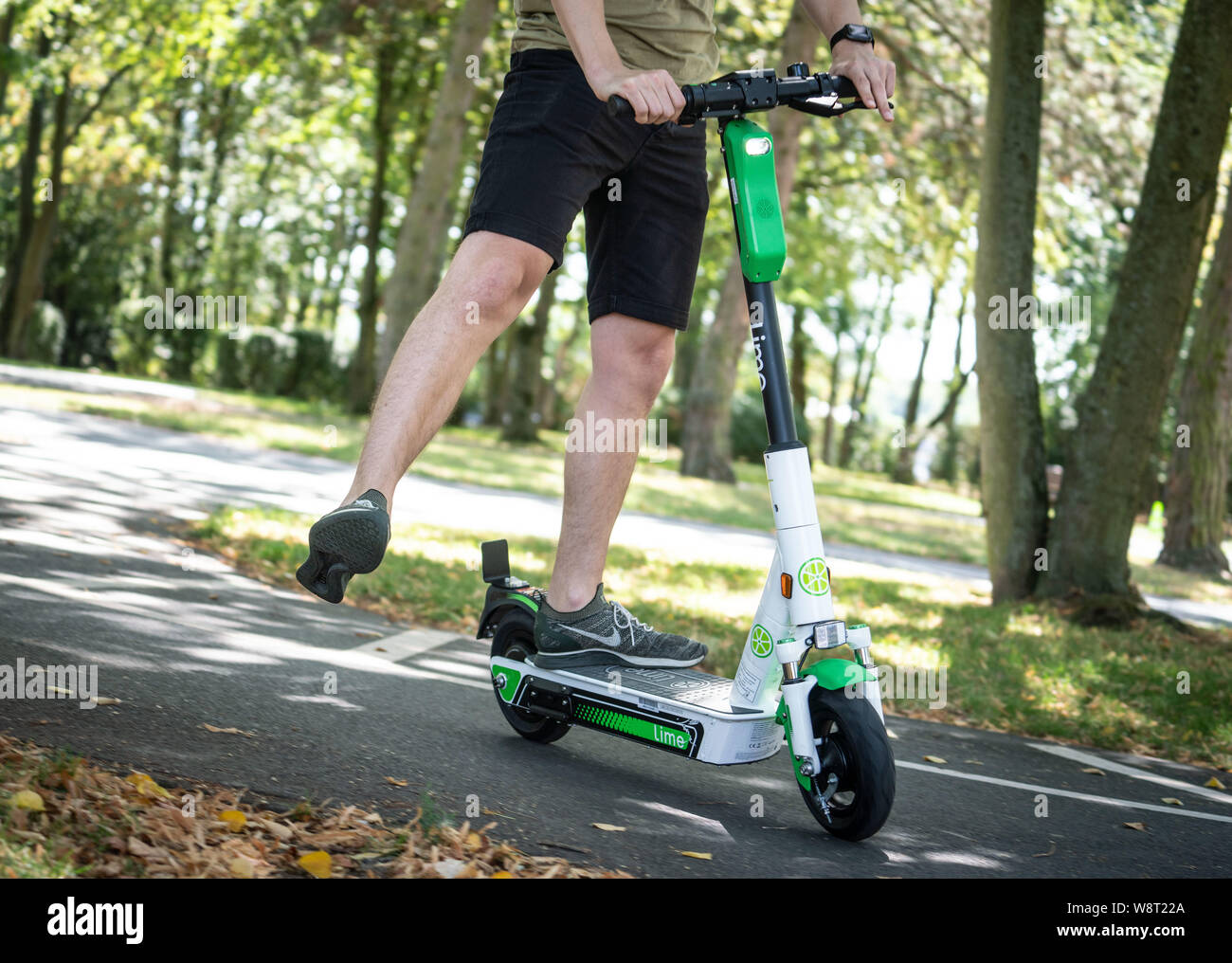 Eschborn, Germany. 11th Aug, 2019. A participant in a driving safety  training course for electric pedal-scooters practises showing a change of  direction with an outstretched leg on a traffic training area. One